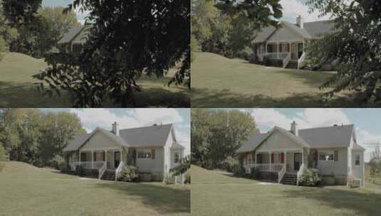 揭示了一个美丽的白色房子与红色装饰从后面的树在一个美丽的园景后院高清在线视频素材下载
