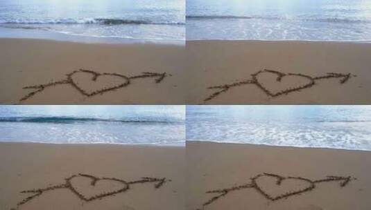 海滩上画着丘比特之箭穿过爱心高清在线视频素材下载