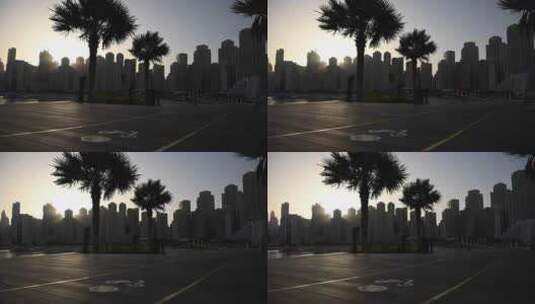 太阳笼罩着城市天际线，棕榈树投下长长的阴高清在线视频素材下载
