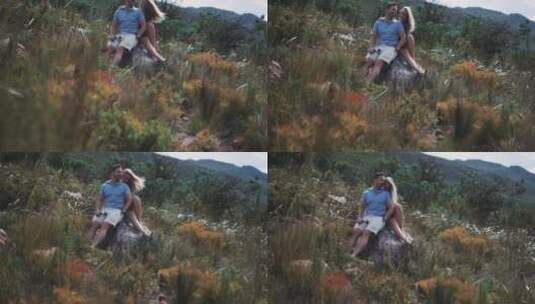 情侣坐在森林里的岩石上休息高清在线视频素材下载