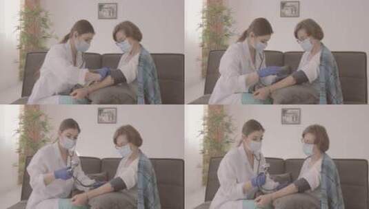 女医生坐在沙发上为病人测量血压高清在线视频素材下载
