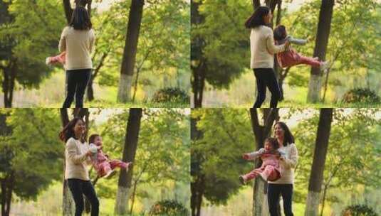 秋天公园里亲子欢乐时光妈妈抱着宝宝转圈高清在线视频素材下载