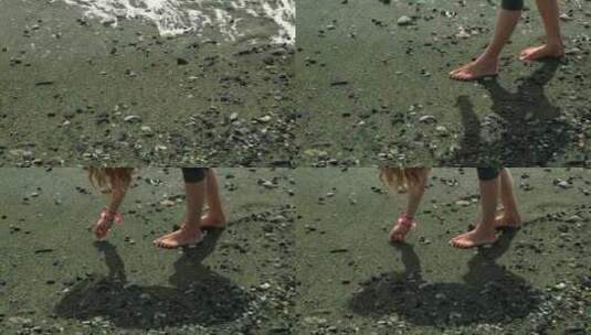 女孩捡起卵石–海滩高清在线视频素材下载