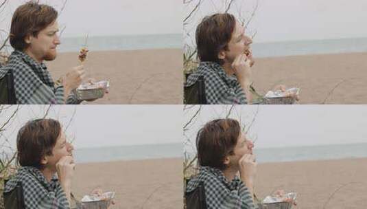 在海边的海滩上野餐，多云。一个穿着格子格高清在线视频素材下载