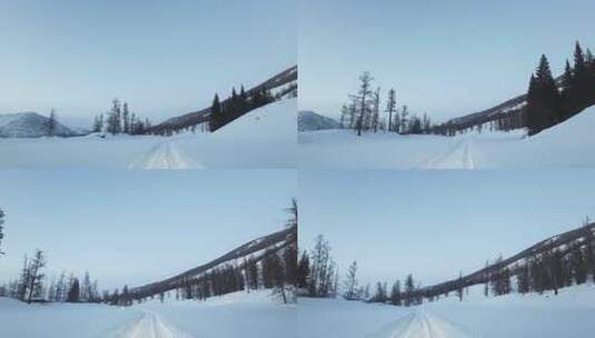 冬季喀纳斯湖雪山脚下汽车在积雪路面上行驶高清在线视频素材下载