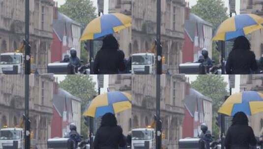 行人在雨中行走的慢镜头高清在线视频素材下载