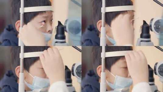 男孩医院诊所检查仪器前做眼科视力检查高清在线视频素材下载