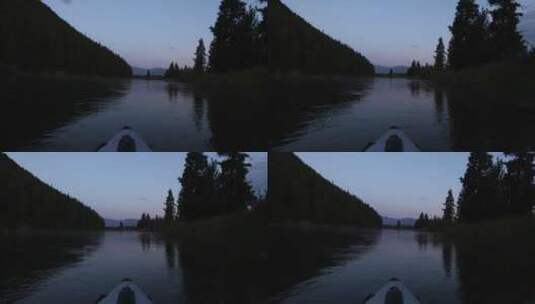 傍晚乘坐独木舟在森林湖水漂流高清在线视频素材下载