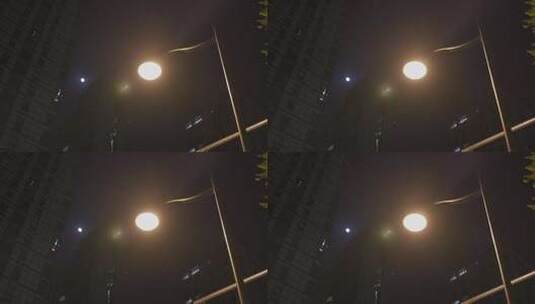 繁华大城市夜晚路灯与月亮同框高清在线视频素材下载