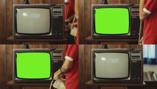 男孩看着复古电视绿屏高清在线视频素材下载