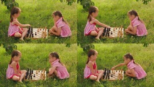 姐妹在草地上下国际象棋高清在线视频素材下载