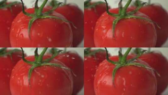 多滴水滴击中带蒂的红色成熟西红柿超慢镜头高清在线视频素材下载