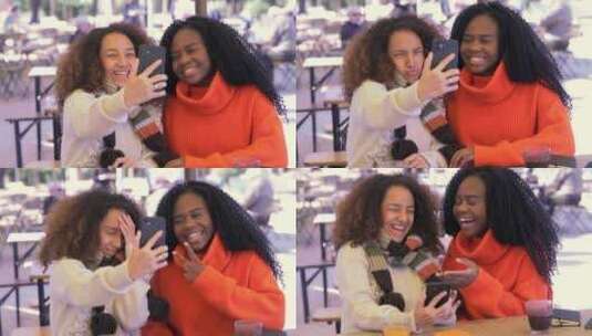 无忧无虑的年轻黑人女孩和西班牙裔女孩自拍做鬼脸高清在线视频素材下载
