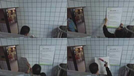 一个中年男人在墙壁上安装制度牌高清在线视频素材下载