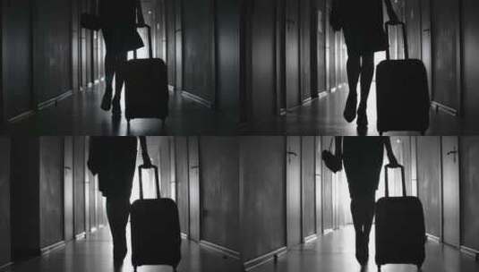 一个女人空姐拖着行李箱背影剪影高清在线视频素材下载