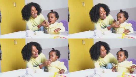 在家里和妈妈一起吃饭的非洲小女孩高清在线视频素材下载