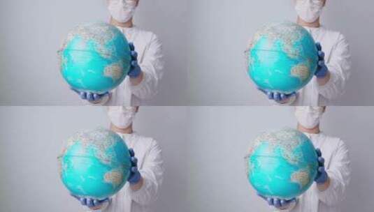 戴口罩人手持地球仪高清在线视频素材下载
