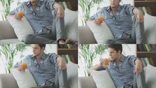 男士坐在沙发上喝饮料高清在线视频素材下载