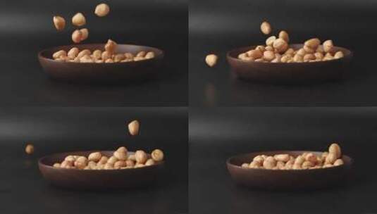 慢镜头拍摄落到碗里的干花生米高清在线视频素材下载