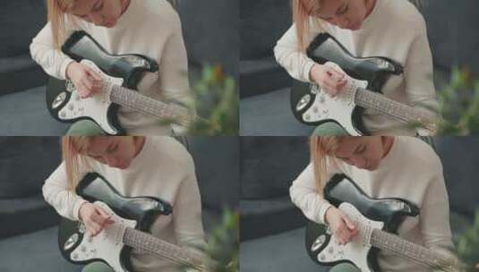 学习弹电吉他的女人高清在线视频素材下载