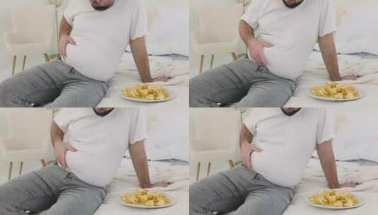 男孩摸他的腹部脂肪高清在线视频素材下载