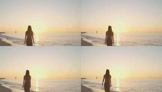 日出阳光下美女走在海边海滩沙滩漫步背影女高清在线视频素材下载