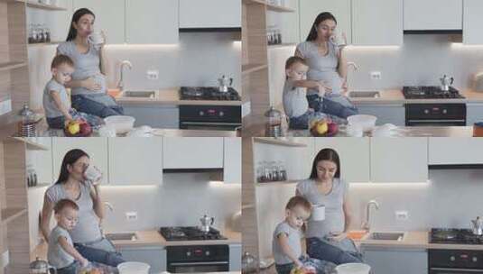 美丽的孕妇站在厨房里喝茶高清在线视频素材下载