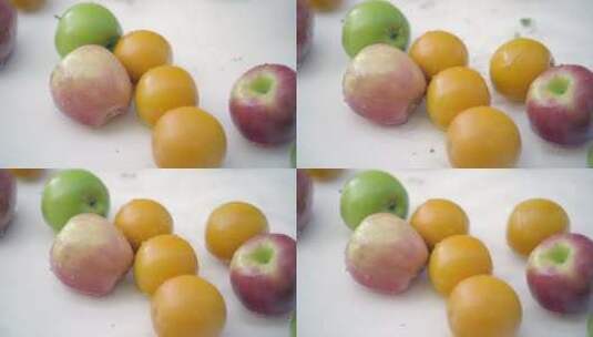 白色背景下苹果和橘子在水中的SLOMO高清在线视频素材下载