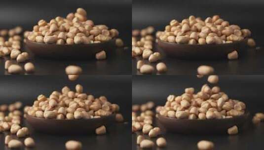 慢镜头拍摄落到碗里的干花生米高清在线视频素材下载