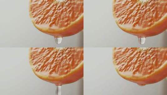 一滴果汁从一个美丽多汁的橘子的边缘落下。高清在线视频素材下载