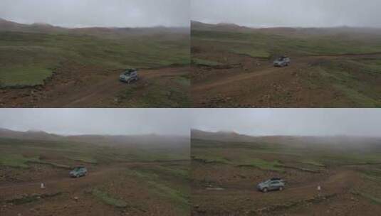 一辆汽车在西藏高原高山草甸越野行驶高清在线视频素材下载