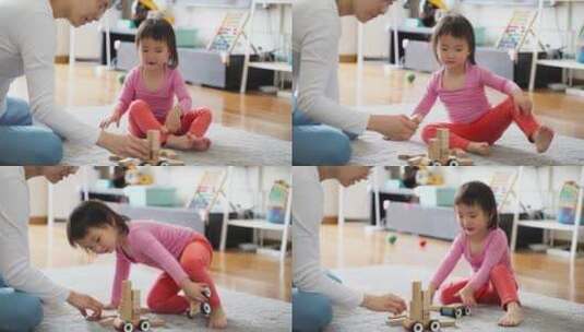 小女孩和妈妈在一起在家里玩耍搭积木高清在线视频素材下载