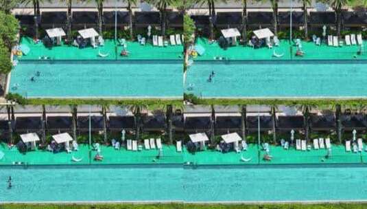 航拍夏天城市旅游度假酒店蓝色水面的游泳池高清在线视频素材下载