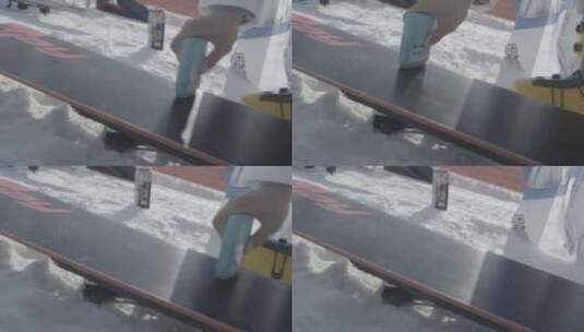 一名滑雪者在给滑雪板打蜡高清在线视频素材下载
