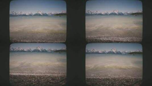 波浪滚滚到雪山附近的湖岸上8毫米电影风格高清在线视频素材下载