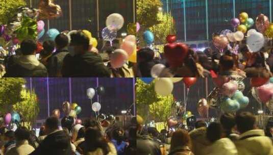 城市节日街头夜晚庆祝跨年拿着气球的人群高清在线视频素材下载