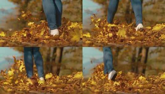 美女行走在秋天的落叶路上慢动作高清在线视频素材下载
