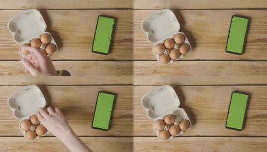 桌面上的红皮鸡蛋绿屏手机高清在线视频素材下载