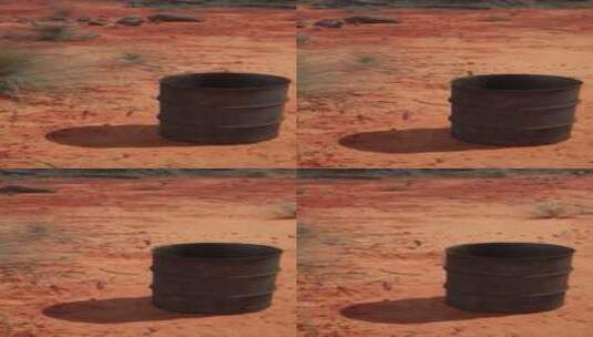 沙子上的旧空生锈桶高清在线视频素材下载