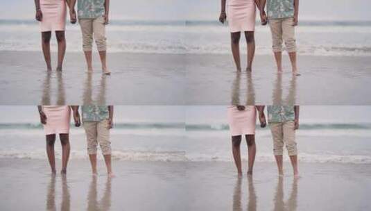 手牵手在海滩上散步的夫妇高清在线视频素材下载