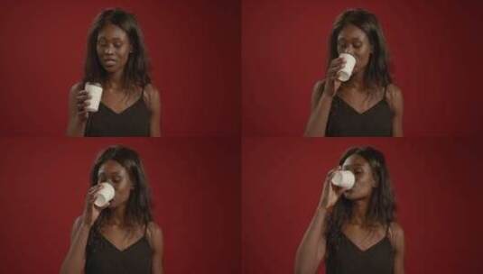 女人用咖啡杯喝水的正面视图高清在线视频素材下载