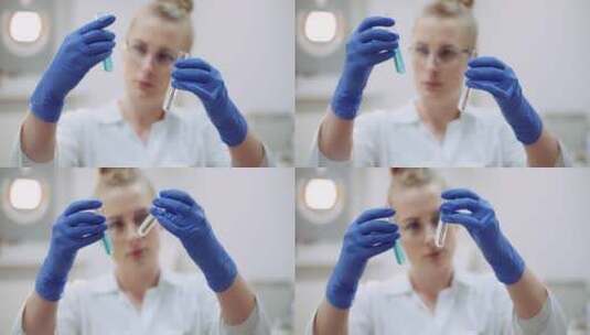 女科学家观察手里的两支试管溶剂高清在线视频素材下载