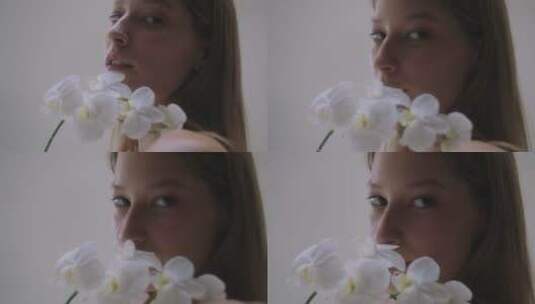 拿白色花朵拍照的女人高清在线视频素材下载