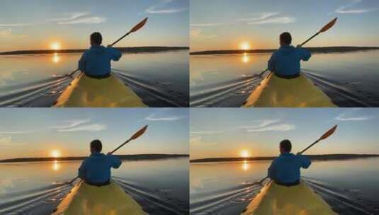 夕阳下男人在湖上划船高清在线视频素材下载