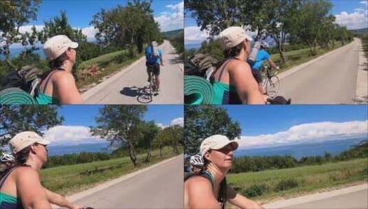 一对自行车爱好者在山地车道上欣赏海景高清在线视频素材下载