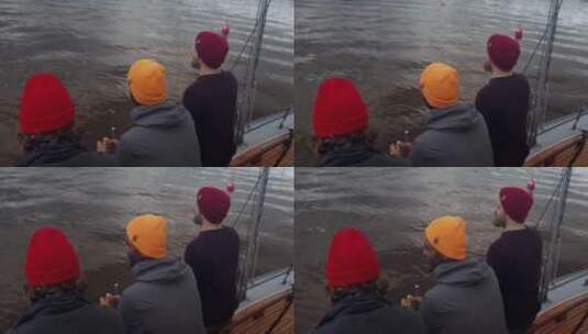 三个男人坐在船边高清在线视频素材下载