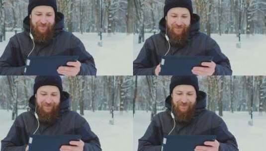 男人在雪地用电脑高清在线视频素材下载