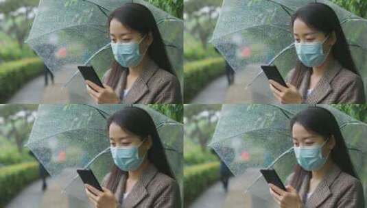 中国女性打伞步行踏春打电话等公交玩手机高清在线视频素材下载
