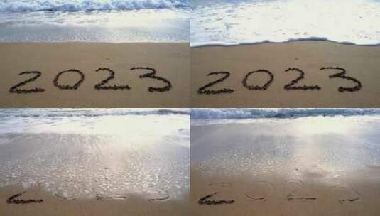 海滩上2023的字被海水冲刷掉高清在线视频素材下载