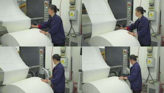 印刷厂工人在大卷纸张整理高清在线视频素材下载